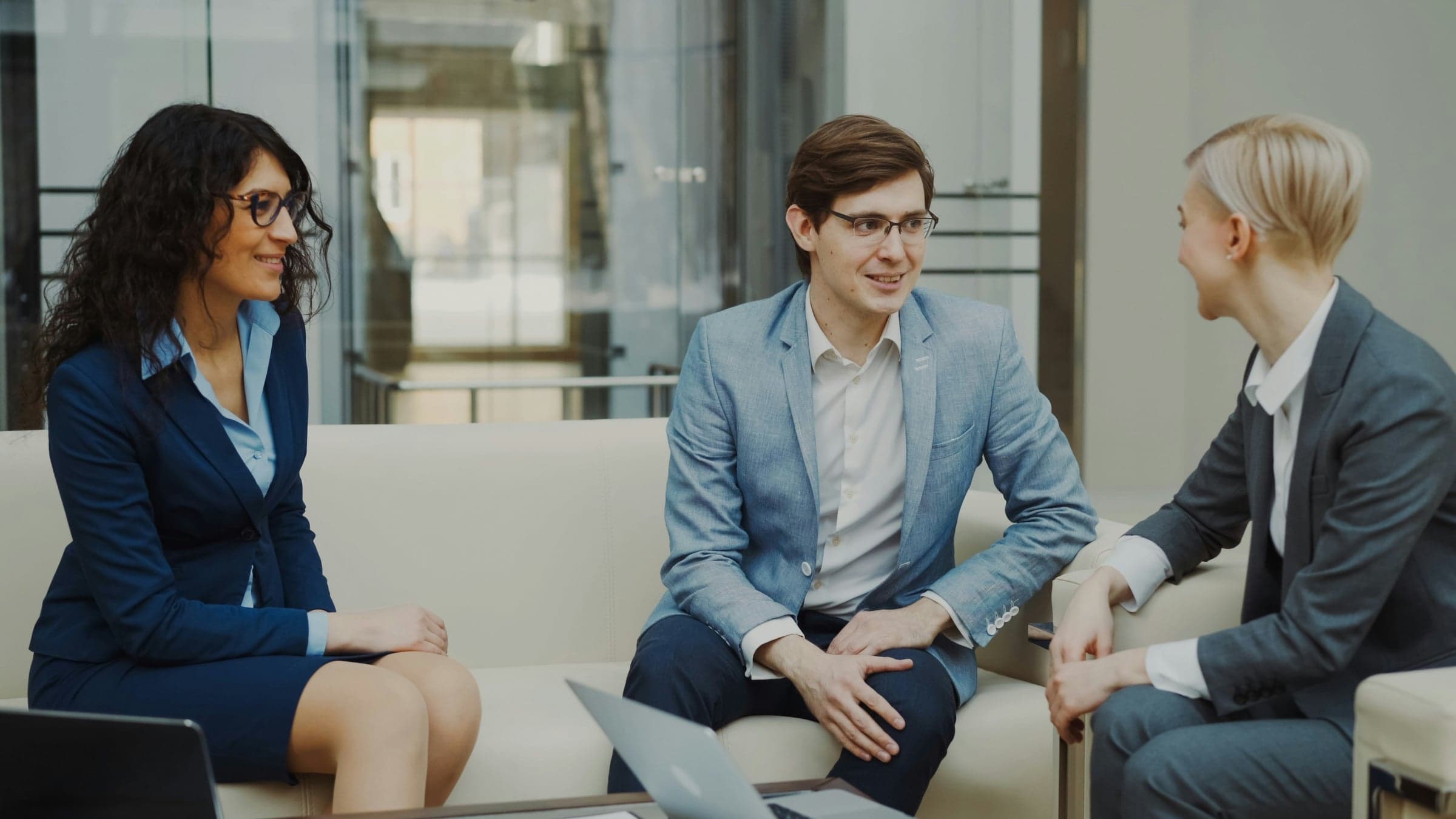 Professionals meeting in a modern office lobby